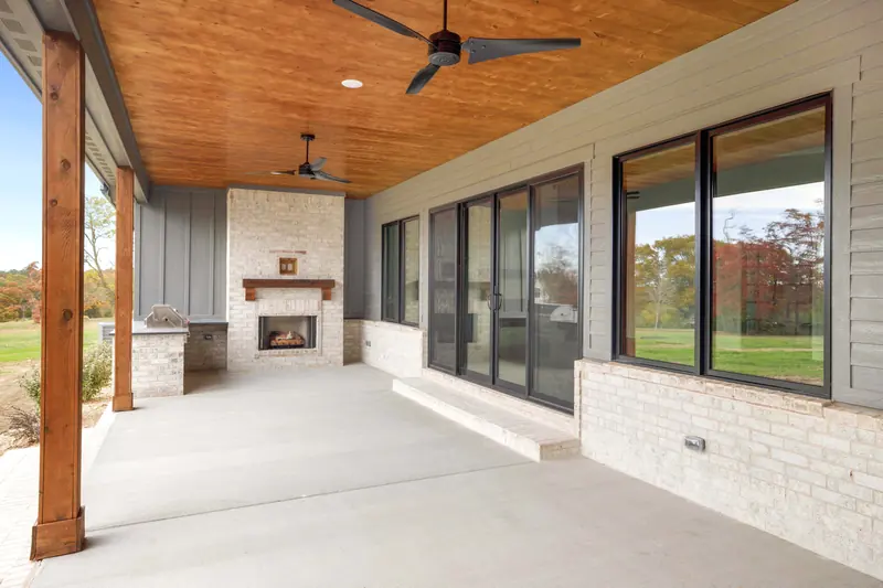 Covered porch with fireplace, The Cedar & Batten Farmhouse